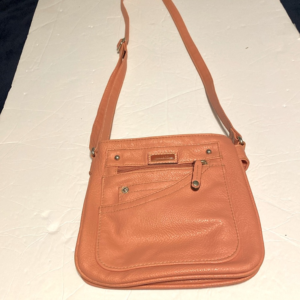 Rossetti crossbody purse in salmon color. Lots of pockets. Outside zipper pocket